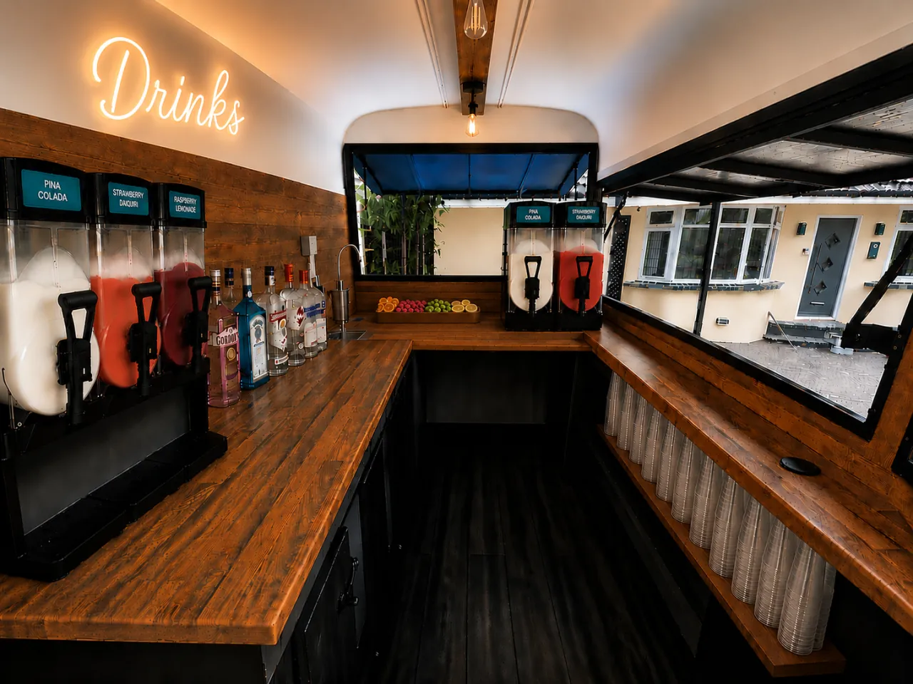 Inside the horsebox bar with frozen cocktail machines and spirits