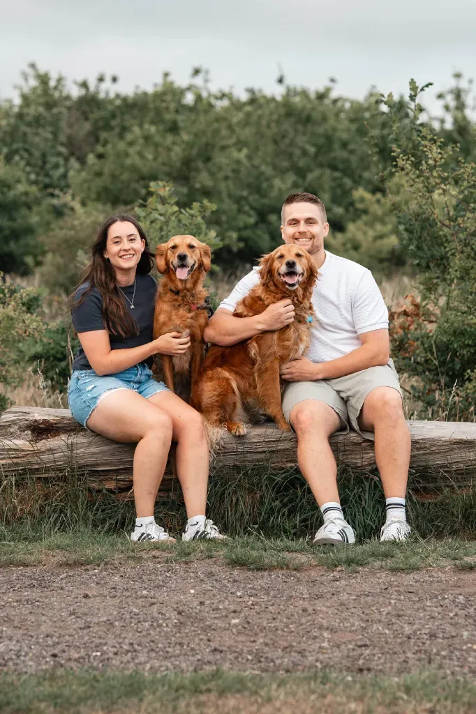 The husband-and-wife team behind The Golden Hour with their two golden retrievers